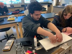student works on physics olympics event