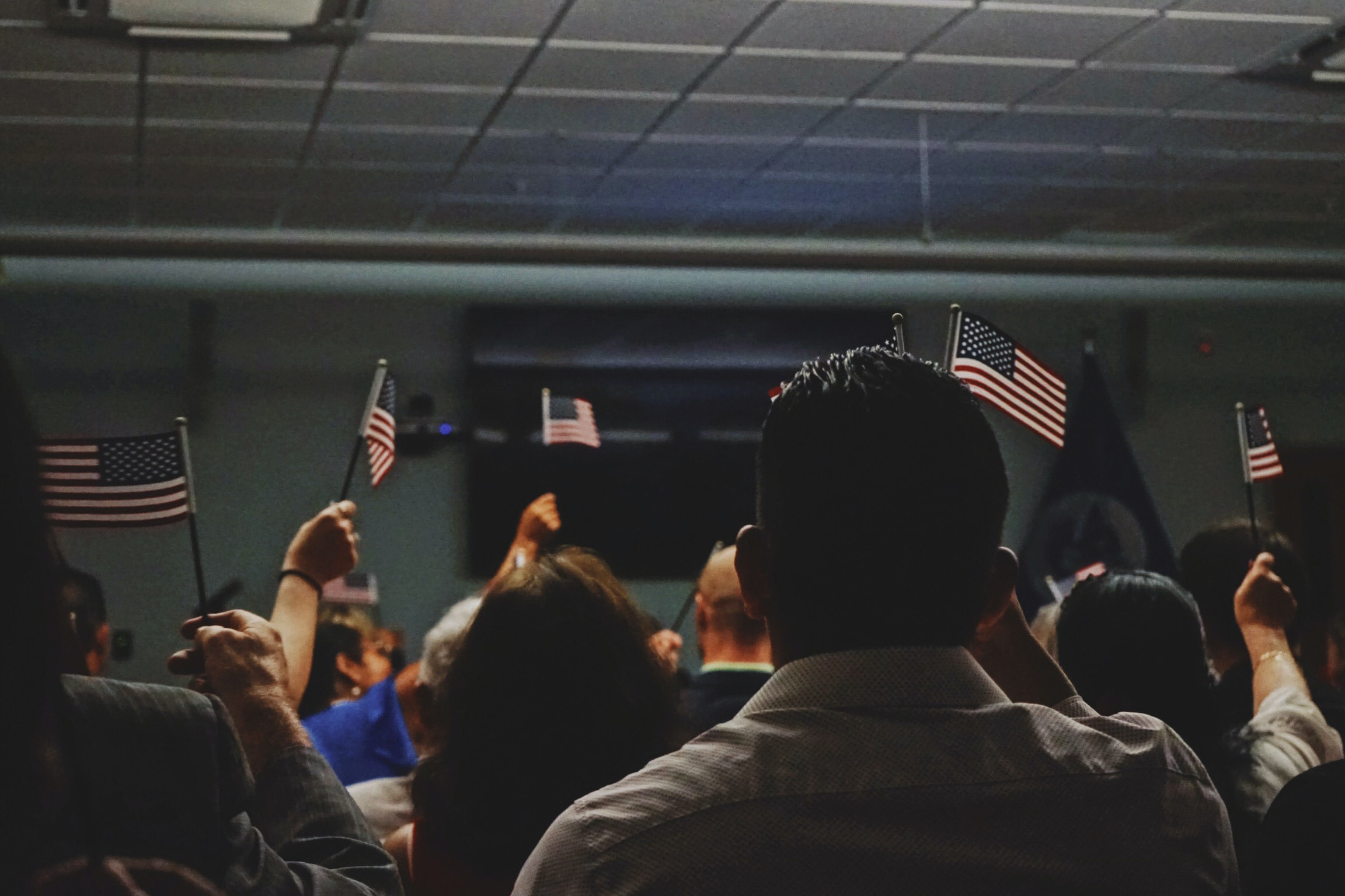 Immigrants waving USA flag