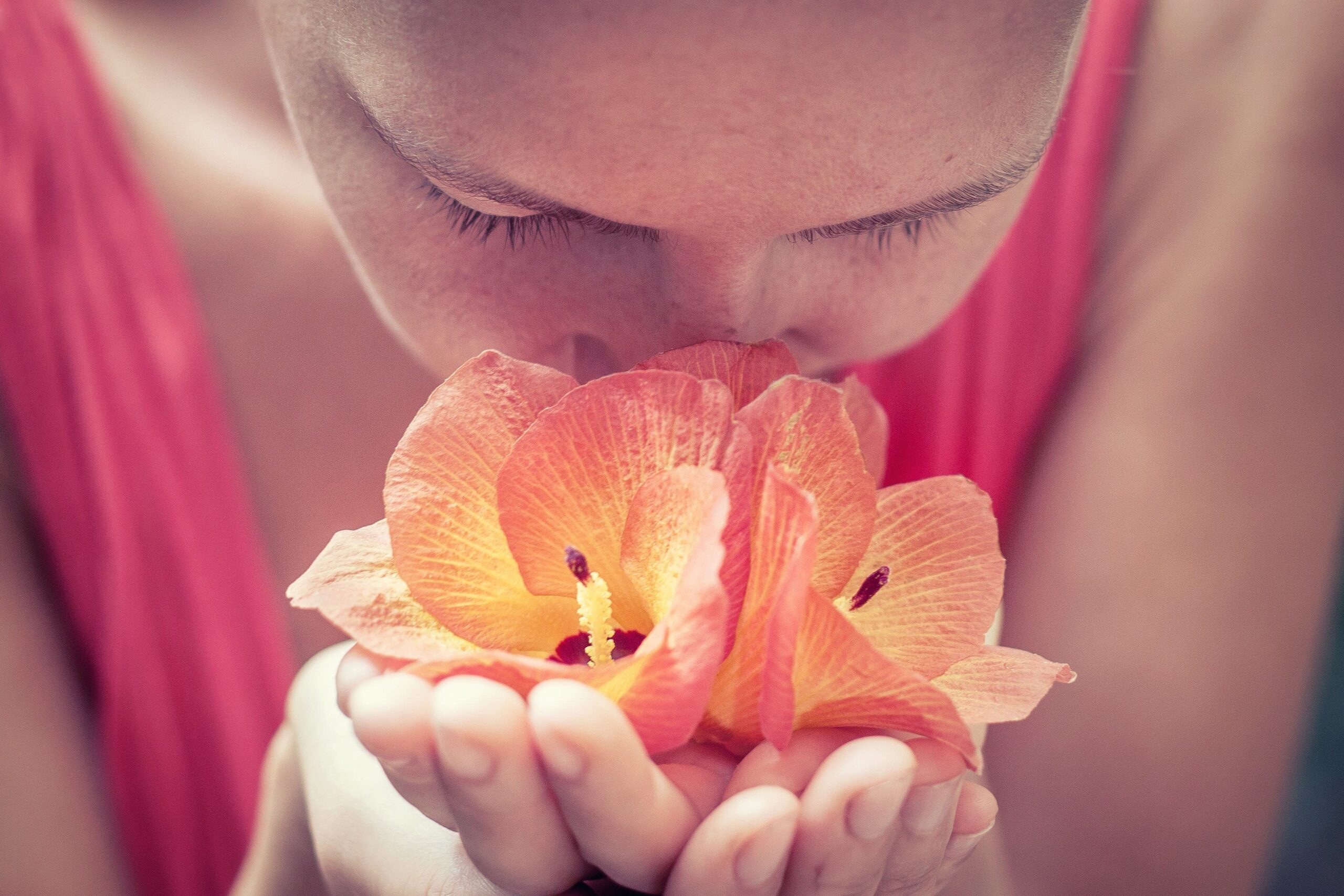person smelling a flower
