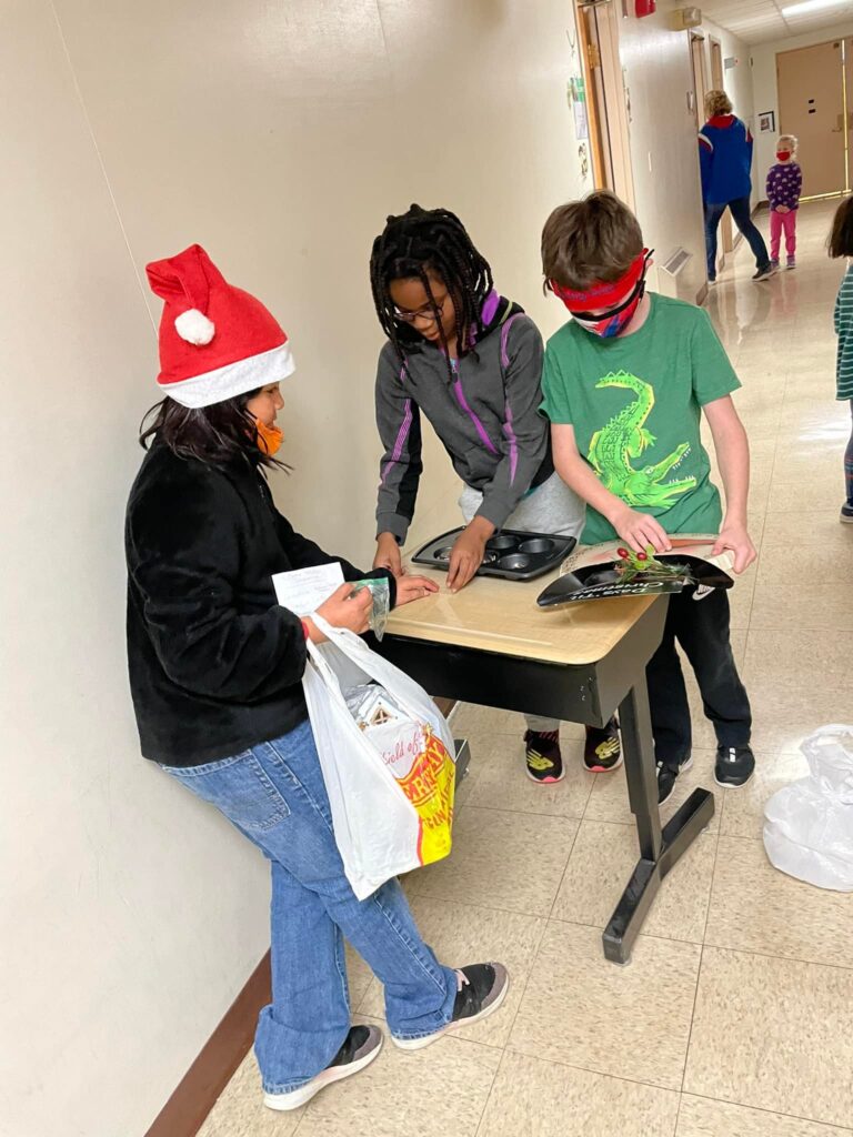 Students taking money from winter shopping experience