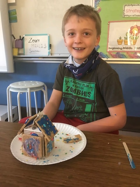 Student with gingerbread house