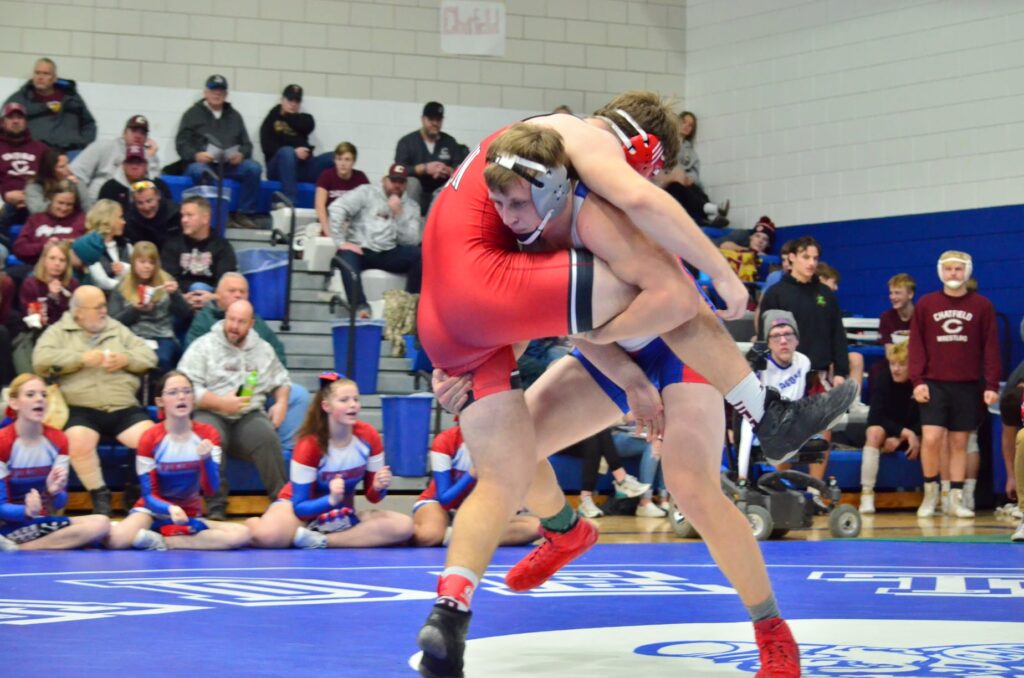 Male wrestler lifting his opponent to put him on his back