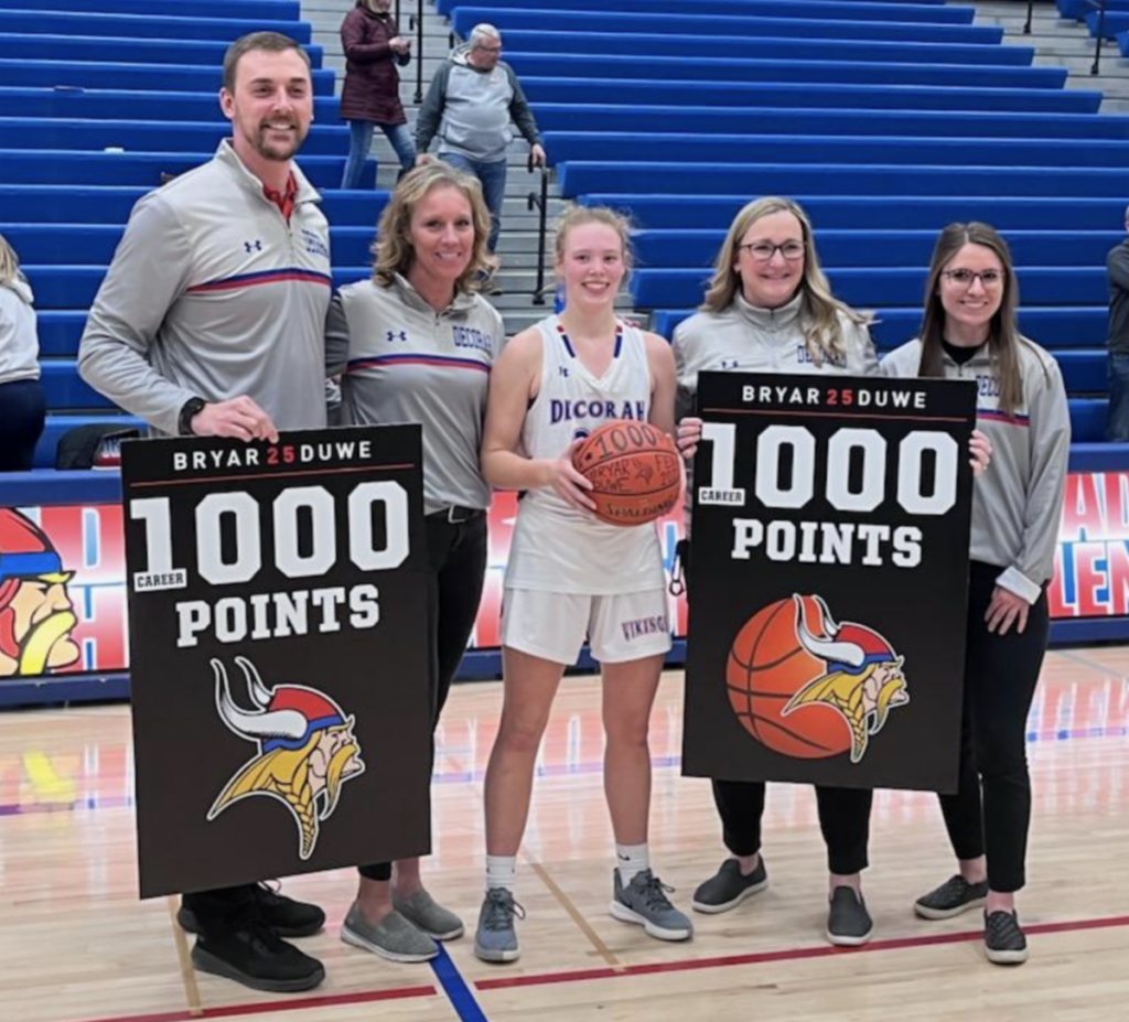 Bryar Duwe with her basketball coaches after scoring her 1,000 point