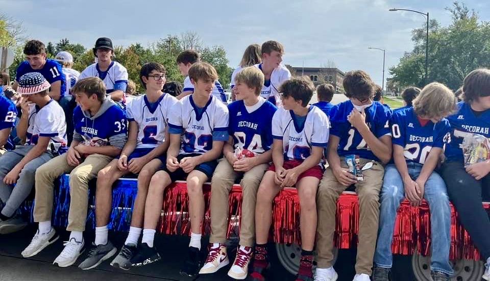 Football players riding in parade