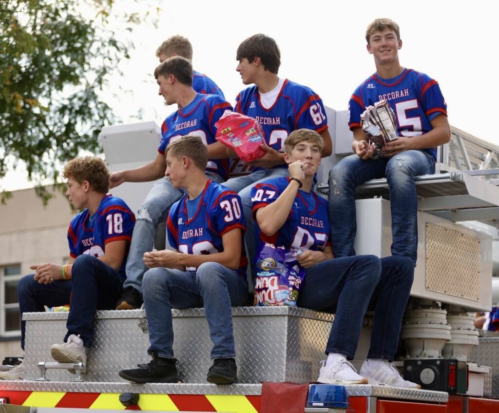 Football players riding on the fire truck