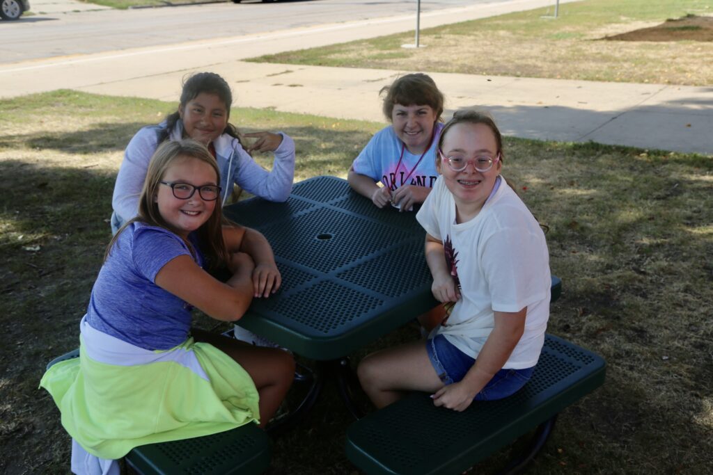Students sitting at the picnic table